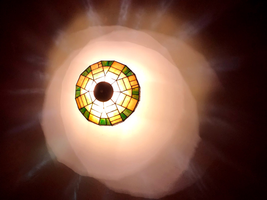 Image of an Antique Lamp casting light on ceiling.
