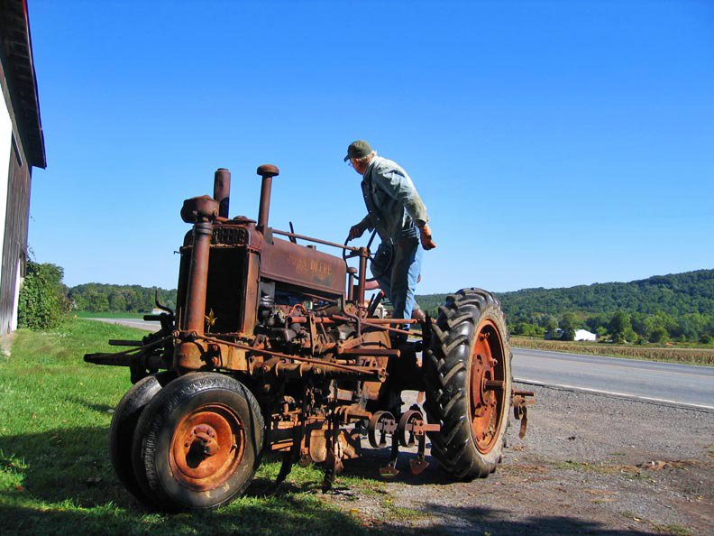 Image of Gordon Davis on a tractor.